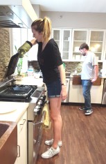Sarah lifts a sheet pan off the oven.